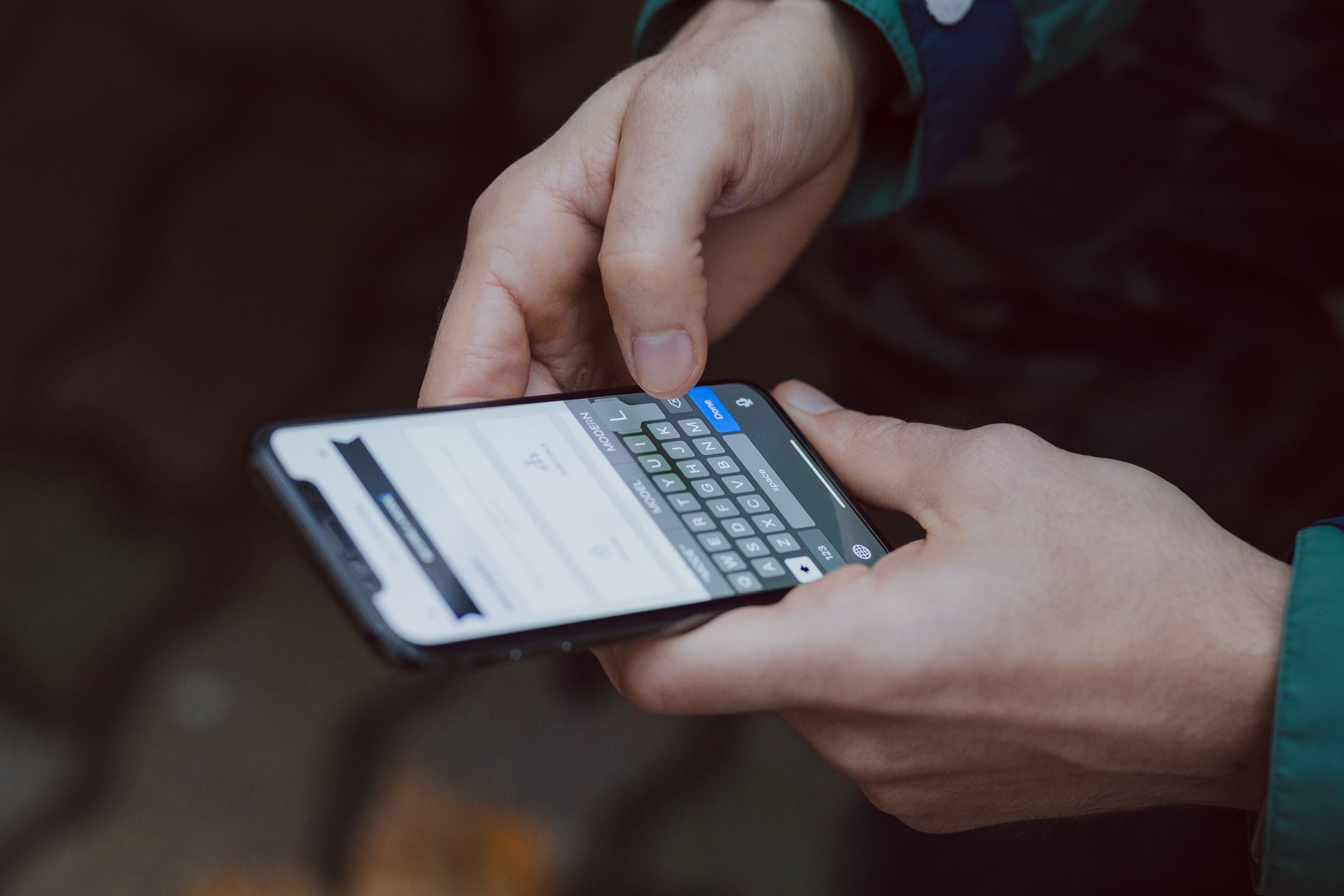 a hand holding a mobile device